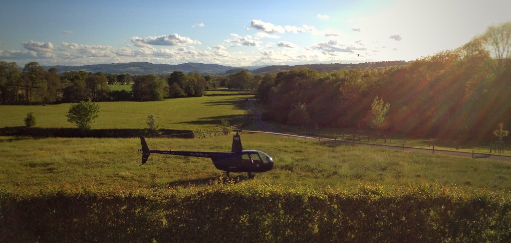 Robinson R44 in a field 
