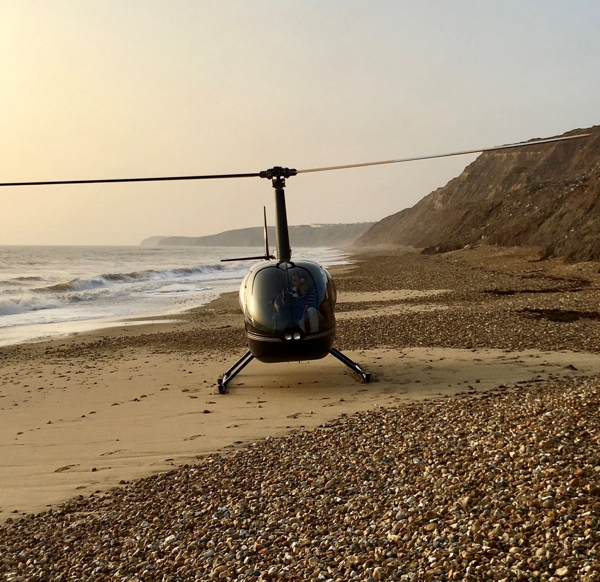 Robinson R44 landing on a beach