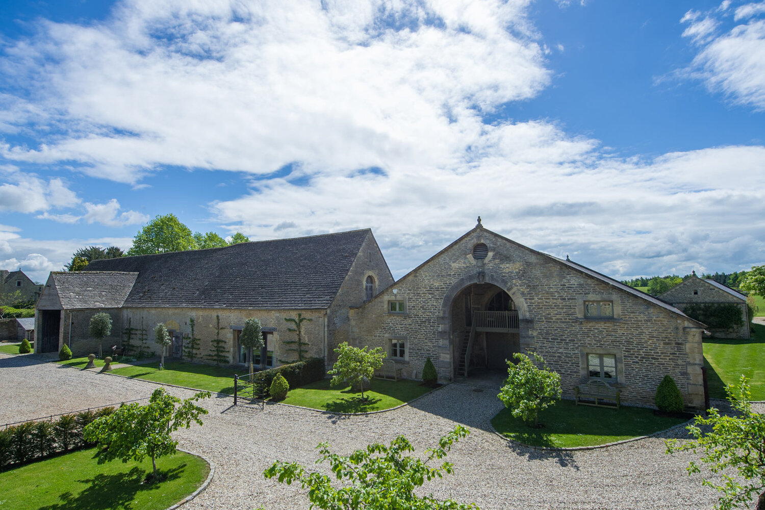 Historic stone barn in scenic rural setting, part of Helipaddy's unique landing sites for helicopter explorers.