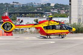 Red and yellow helicopter at a helipad, associated with Helipaddy landing site directory.