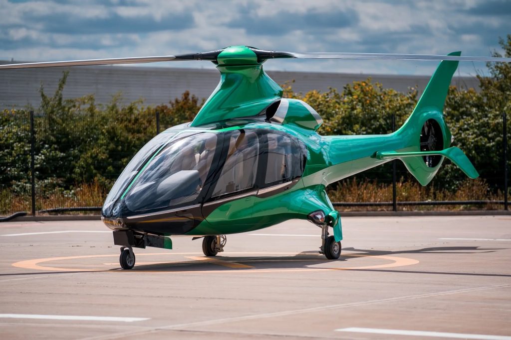Green luxury helicopter HX50 on helipad, relevant to Brexit permit to fly
